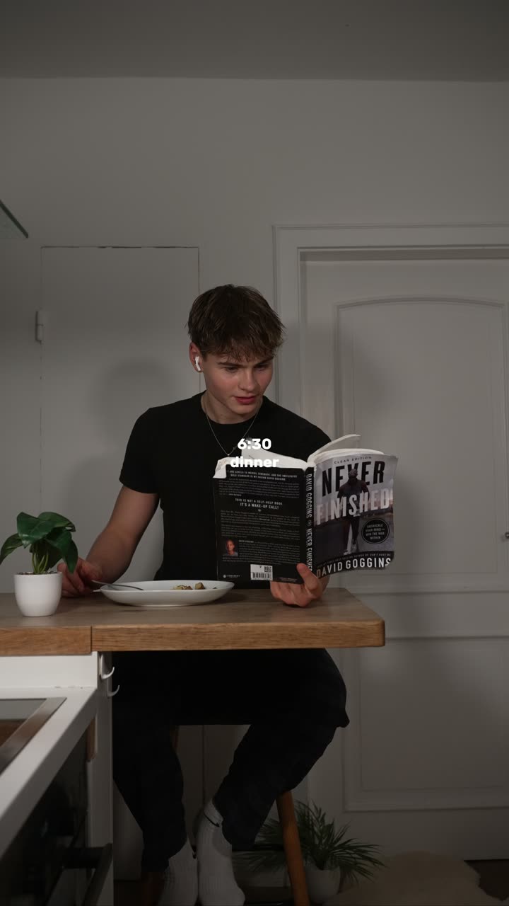 Noah reading at a wooden counter, from his own routine video