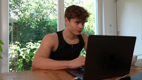 Noah working at his laptop in an illustrative call view